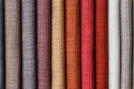 samples of multi-colored fabrics for curtains close-up. Selection of fabric for interior decoration